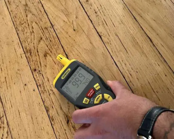 Moisture meter on the hardwood floor