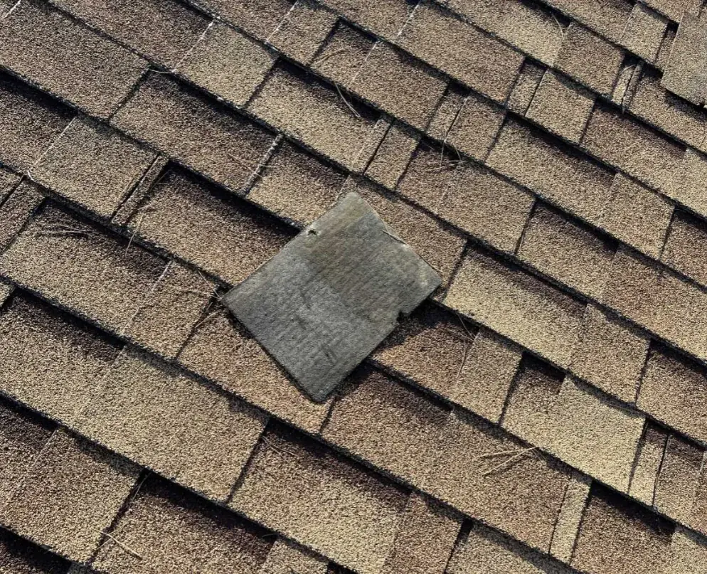 Displaced shingle on the roof