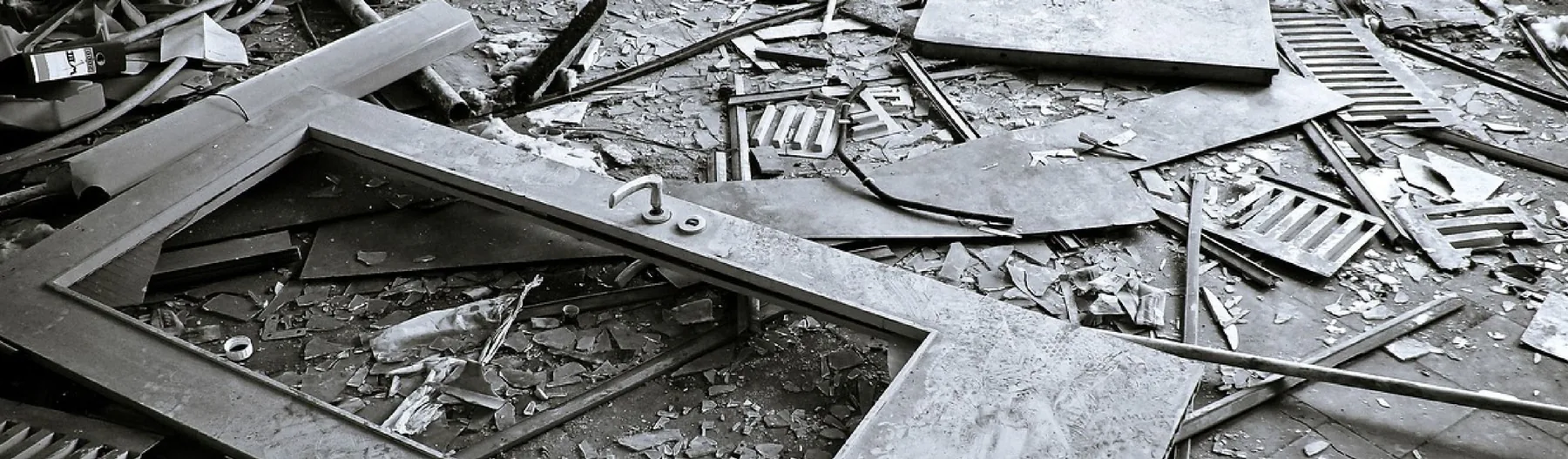 Debris and a broken door frame on the floor after a break-in